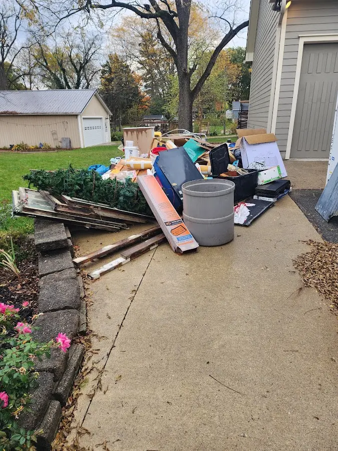 Dumpster being loaded with debris for Estate Cleanout Dumpster Rental in McKeesport